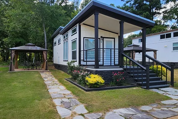 Villa 104 seen from the front, with its covered porch and gazebo