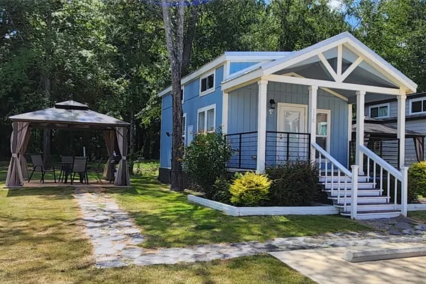 Villa 110 seen from the front, with its covered porch and gazebo